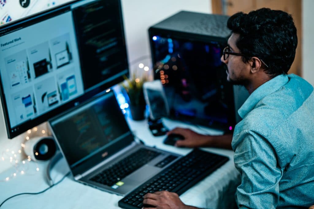 A person sat at a desk using a PC and employing time management to create a work schedule.